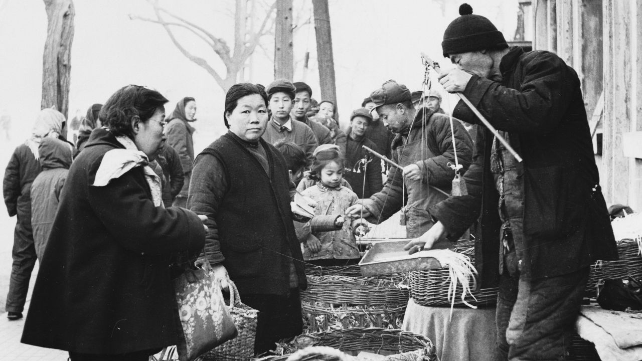 May 1959:  Customers buying fresh vegetables from a market in Beijing (Peking), China's capital city. 