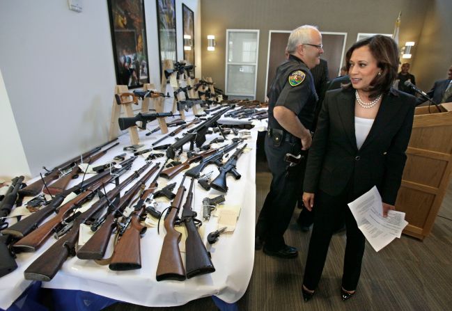 Harris looks over seized guns following a news conference in Sacramento, California, in June 2011. Harris became California's attorney general in January 2011 and held that office until 2017. She was the first African American, the first woman and the first Asian American to become California's attorney general.