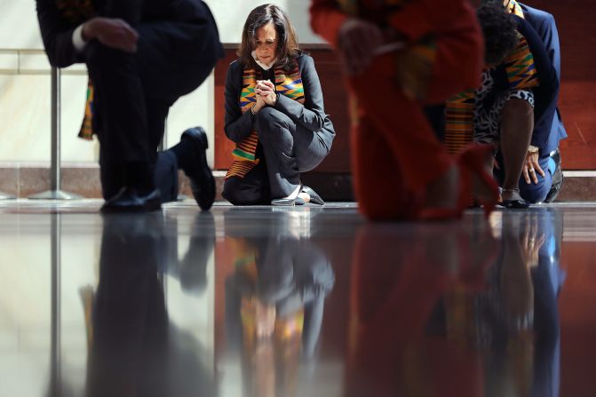 Harris joins fellow Democrats from the House and Senate as they kneel in silence to honor George Floyd at the US Capitol in June 2020.